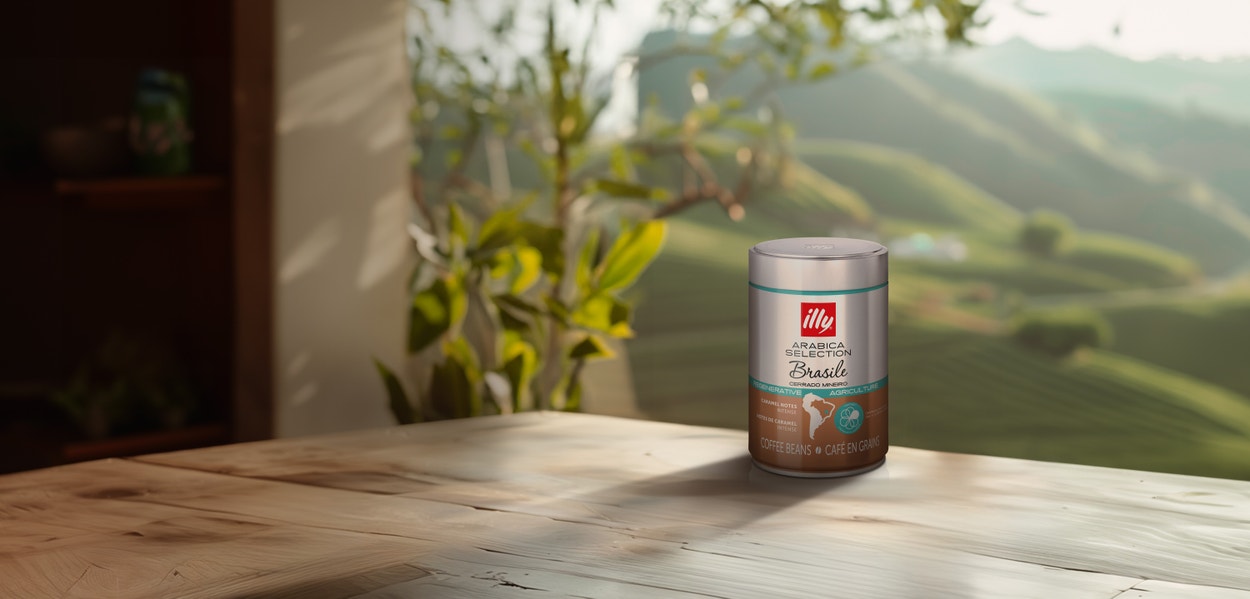 illy coffee on a wood table overlooking green coffee-country hills